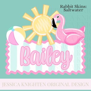 May include: A whimsical illustration featuring a pink flamingo pool float, a yellow sun, and a beach ball. The name "Bailey" is written in pink script. The design has a beach theme with a turquoise background and the text "Rabbit Skins: Saltwater".