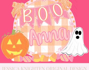 May include: A hot pink Halloween-themed design featuring a pumpkin, ghost, and candy corn. The design includes the word "BOO" on a banner and the name "Anna" in a pink font. The background is a pink and white gingham pattern.