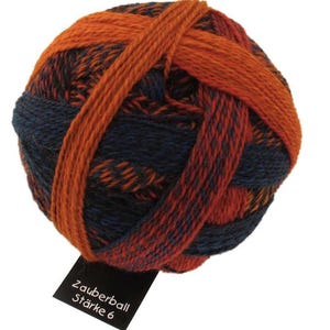 May include: A ball of orange and blue yarn with a label that reads "Zauberball Stärke 6".