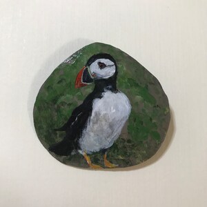 An Atlantic Puffin is hand painted onto piece of gourd, pin and bail backing added to be worn as wearable fine art.