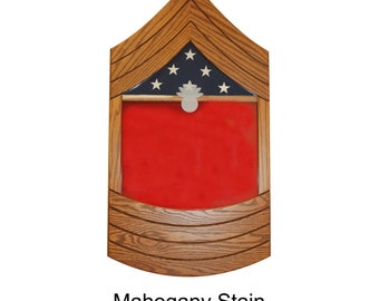 May include: A wooden shadow box with a red felt background and a small American flag with five stars. The shadow box is stained mahogany and has a chevron design.