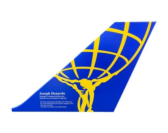 May include: A blue and yellow award plaque with a globe and a figure holding it up. The plaque reads "Joseph Denardo Manager, Commercial Revenue Defence & Government Programs The Men And Women Of Atlas Air Thank You For Your Dedication And Tireless Support Over The Past 16 Years We Hope You Enjoy Your Retirement."