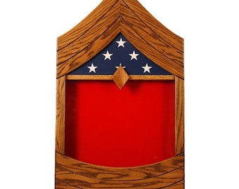 May include: A wooden shadow box with a red felt background and a blue and white American flag with five stars in the top section. The shadow box is designed to hold military medals and other memorabilia.