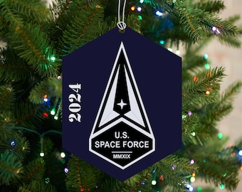 May include: A blue hexagonal Christmas bauble featuring a white Space Force logo and the text "U.S. SPACE FORCE MMXIX" and "2024".