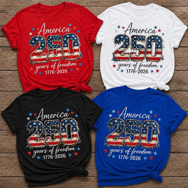 May include: Four short-sleeved t-shirts in red, white, black, and blue. Each shirt features the text "America 250 years of freedom 1776-2026" in a patriotic design with stars and the American flag colors.