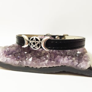 May include: Black leather choker with a silver triple moon and pentagram charm.