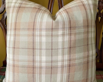 May include: Square cushion with a plaid pattern in beige, cream, and brown. The cushion is on a wooden chair with a carved back. The plaid design features intersecting lines, creating a classic, timeless look for home decor.