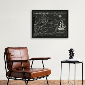 May include: A black and white framed print of a treasure map of Oak Island, featuring a ship and the text "Treasure Map of Oak Island, 1861".