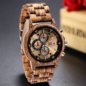 May include: A brown wooden wristwatch with a gold face and black accents. The watch has a chronograph feature and a date window. The watch face has the text "18 CHRONOGRAPH" on it.