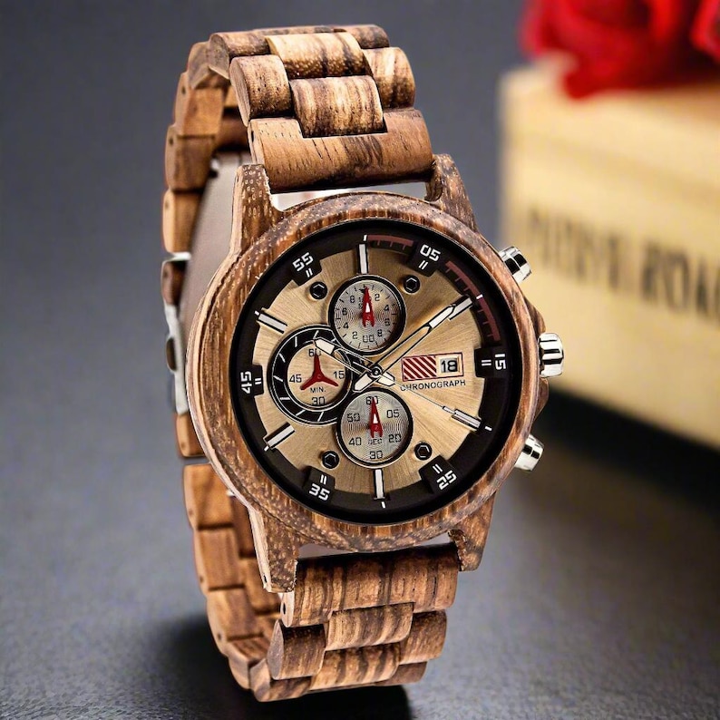 May include: A brown wooden wristwatch with a gold face and black accents. The watch has a chronograph feature and a date window. The watch face has the text "18 CHRONOGRAPH" on it.