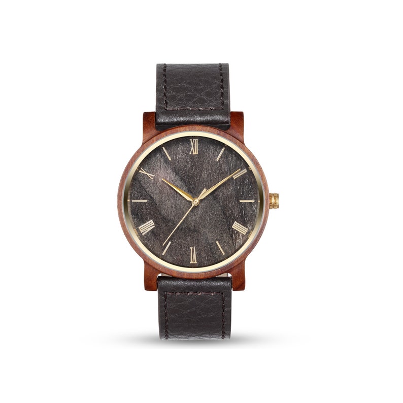 May include: A brown wooden wristwatch with a black leather strap and a gold face with Roman numeral markings.