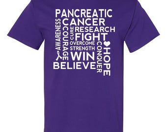 May include: A purple t-shirt with white text. The text includes the words "Pancreatic Cancer, Awareness, Courage, Cure, Research, Fight, Overcome, Strength, Win, Believe, Conquer, Hope". A ribbon and heart are also included.