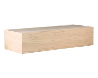 May include: A natural wood shelf with a light brown finish. The shelf is rectangular and has a smooth surface.