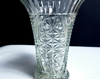 May include: A clear glass vase with a diamond pattern and a scalloped rim.