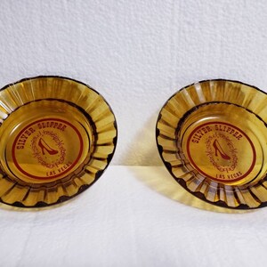 Set of 2 Vintage Silver Slipper Casino Las Vegas, NV Amber Glass 4.5&quot; Round Souvenir  Ashtrays Red Graphics Fluted Rim ca. 1960s