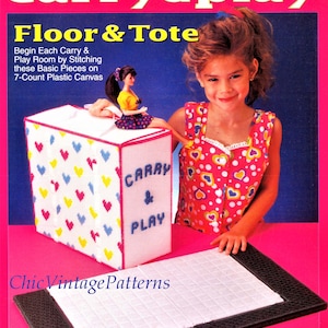 May include: A vintage craft kit for a Fashion Doll Carry & Play set. The kit includes a white plastic canvas tote decorated with colorful hearts, a doll, and a play mat. The text on the tote reads "Carry & Play".