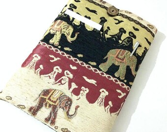 Pode incluir: Uma capa para laptop de tecido multicolorido com um design de elefante. A capa tem um bolso na frente com um fecho de botão.