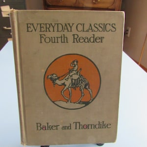 May include: A vintage "Everyday Classics Fourth Reader" book. The cover is tan with black text and an orange circle illustration of a person riding a camel. The book is by Baker and Thorndike.