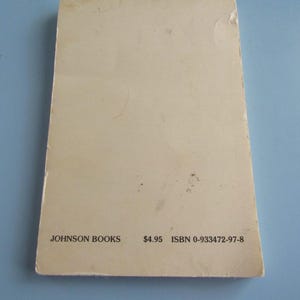 May include: A rectangular book cover with a light beige color. The text "JOHNSON BOOKS" is printed in black at the bottom left, with "ISBN 0-933472-97-8" on the right. The cover has minor wear and tear.