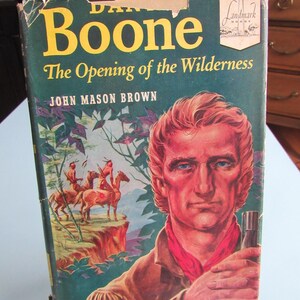 May include: A hardcover book titled Daniel Boone: The Opening of the Wilderness by John Mason Brown. The dark green cover features a portrait of a man with reddish hair and a red neckerchief, alongside an illustration of two figures on horseback.