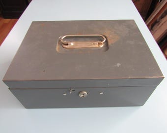 May include: A gray metal cash box with a lock and a handle on the top.