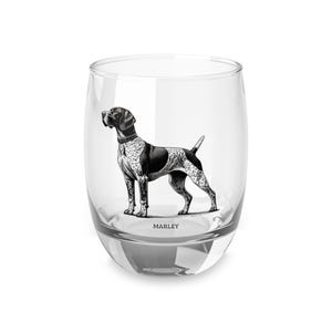 May include: A clear, stemless glass with a black and white illustration of a dog. The dog is a Pointer breed, with a black saddle and spotted coat. The name "MARLEY" is printed below the dog.