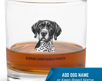 May include: A clear glass tumbler with a black and white illustration of a German Shorthaired Pointer dog. The text "GERMAN SHORTHAIRED POINTER" is printed below the dog. The glass is filled with a brown liquid.