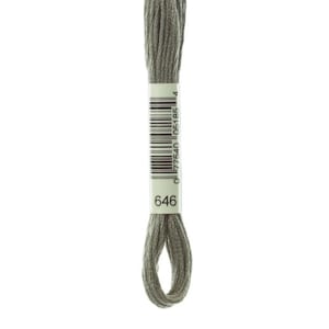 May include: A skein of embroidery floss in a muted, grayish-green color. The floss is wrapped and labeled with a barcode and the number "646". The thread is tightly wound, with a loop at the bottom.