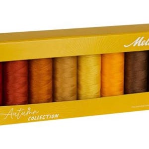 May include: A yellow box set of Mettler thread spools in autumn colors. The box has a window showing the thread colors: red, orange, yellow, brown, and olive green. The box is labeled "Autumn Collection".