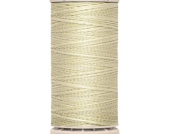May include: A spool of Gütermann thread in a light beige color. The spool has a white top and bottom with the brand name "Gütermann" printed on the top. The bottom of the spool has the text "200 m - 220 yds/vgs".