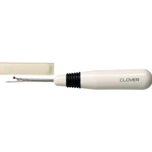 May include: A white seam ripper with a black grip and the word "CLOVER" printed on the handle. The seam ripper has a silver blade and a red ball at the tip. A beige protective cover is also included.