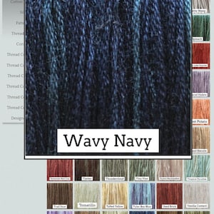 May include: A close-up of a skein of "Wavy Navy" hand-dyed cotton and silk thread from Classic Colorworks.