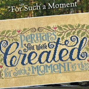 May include: Cross-stitch sampler with the text "Perhaps You Were Created for Such a Moment as This." The design features blue and light blue lettering, green leaves, and small red hearts on a tan background. The phrase "For Such a Moment" is above the sampler.