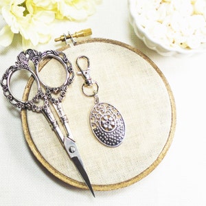 Silver Oval floral zipper pull or scissor fob