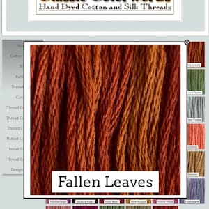 May include: Close-up of a bundle of hand-dyed cotton and silk threads in shades of orange, red, and brown. The threads are arranged in vertical rows and have a slightly textured appearance. The text "Fallen Leaves" is printed below the threads.