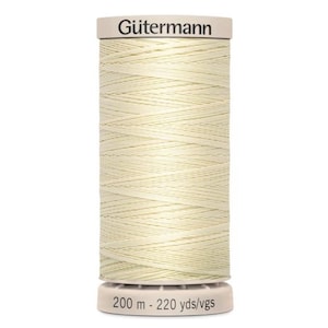 May include: A spool of off-white sewing thread by Gütermann. The spool has a white top and bottom with the brand name printed on the top. The bottom of the spool has the text "200 m - 220 yds/vgs". The thread is tightly wound around the spool.