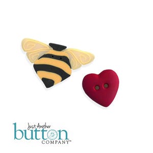 May include: Two decorative buttons: a bee with yellow wings and black and yellow striped body, and a red heart with two holes. The bee button has a black head. The buttons are on a white background.