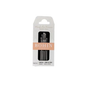 May include: A package of Bohin France cross stitch needles. The white and beige package has the text "Manufacture Française Depuis 1833" and "BOHIN FRANCE". The package also has the text "18/22 CANEVAS - POINT DE CROIX CANVAS - CROSS STITCH".