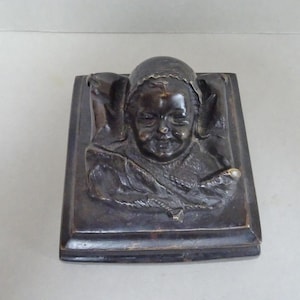 Bronze relief.  Paperweight or decorative bronze. Late 19th Century.  Smiling Child. Probably French.