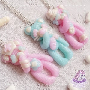 Three polymer clay necklaces depicting pastel teddy bears dressed as nurses and hospital patients.