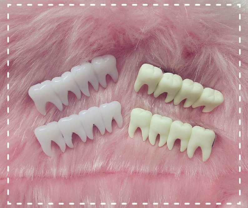 hairclips with four fake teeth in a line, two on each side of the image