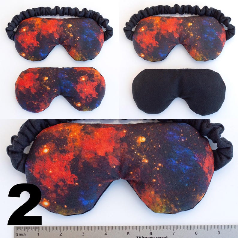 May include: A pair of black sleep masks with a galaxy print. The mask has a black elastic band. The mask is shown in three different positions. The number "2" is visible in the bottom left corner of the image.