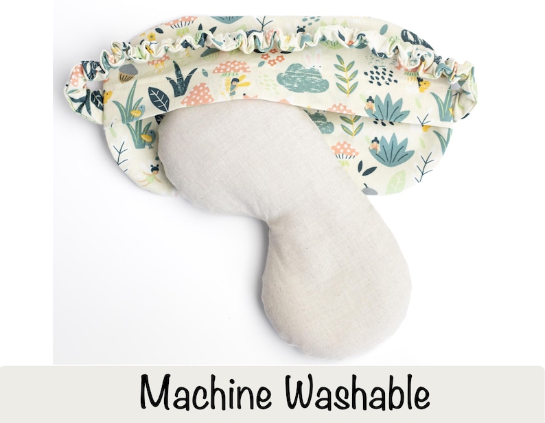 May include: A white sleep mask with a floral print and a light beige eye mask. The sleep mask has a ruffled edge and the text "Machine Washable" is printed below the image.