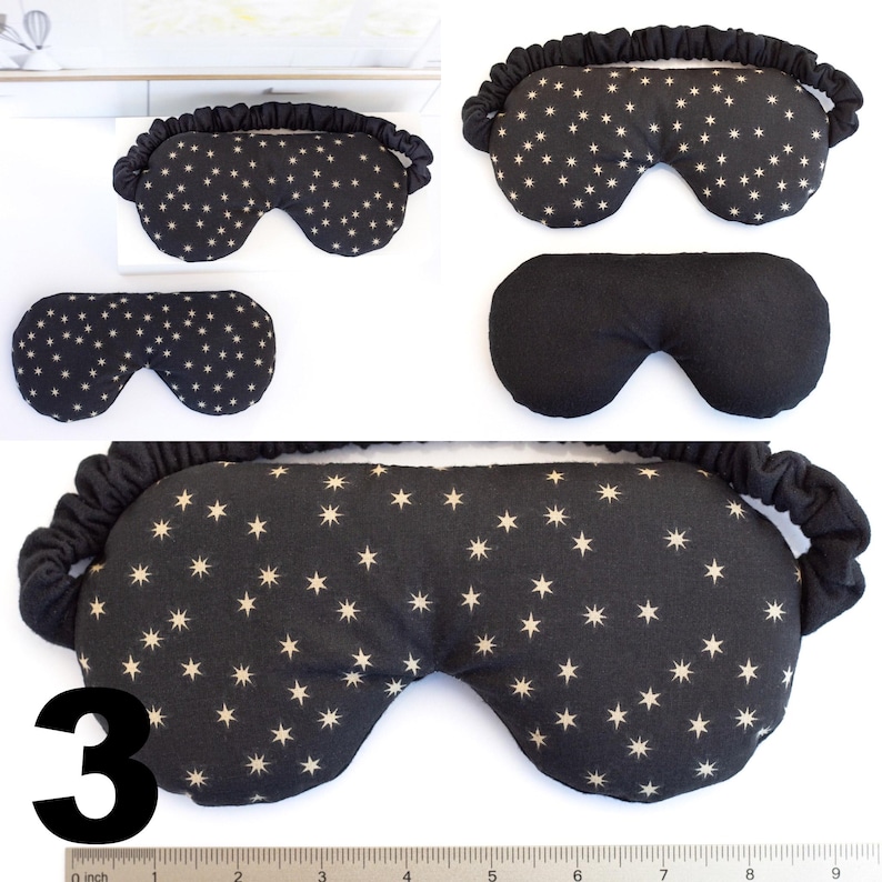 May include: Three black sleep masks with white stars. The top mask has a black elastic band. The middle mask is solid black. The bottom mask has a black elastic band and the number "3" in white.