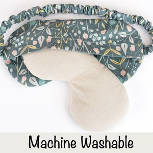 May include: A teal blue sleep mask with a floral pattern. The mask is made of soft fabric and has an elastic band for a comfortable fit. Machine Washable.