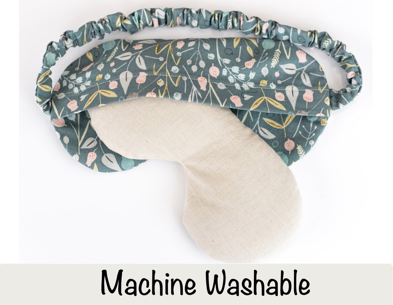 May include: A teal blue sleep mask with a floral pattern. The mask is made of soft fabric and has an elastic band for a comfortable fit. Machine Washable.
