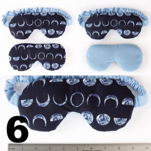 May include: A blue sleep mask with a crescent moon pattern on a black background. The mask is shown in three different positions. The number 6 is visible in the bottom left corner of the image.