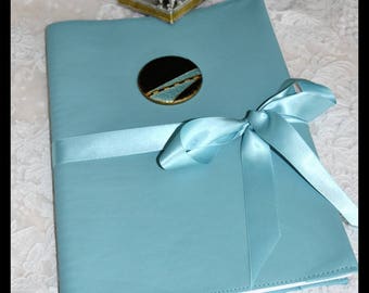 Travel sketchbook or drawing book and its turquoise leather case