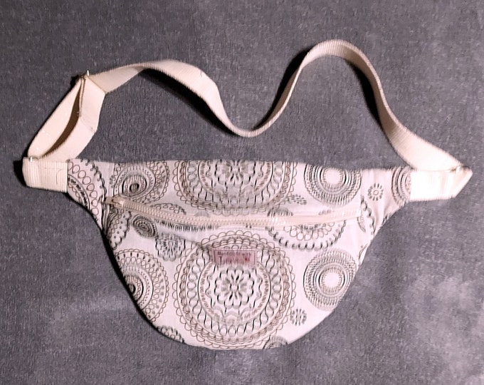 Light beige linen and cotton fanny pack with brown graphic designs with shoulder strap
