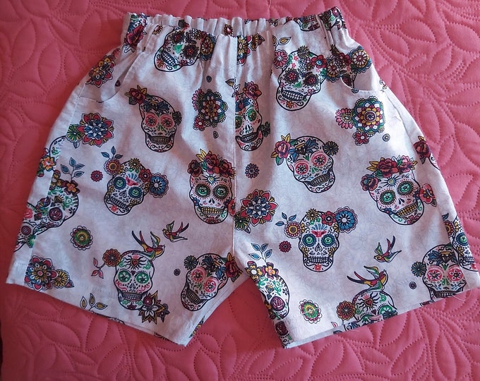 4-year-old boy's shorts with skull and crossbones on an off-white background. Last Markdown